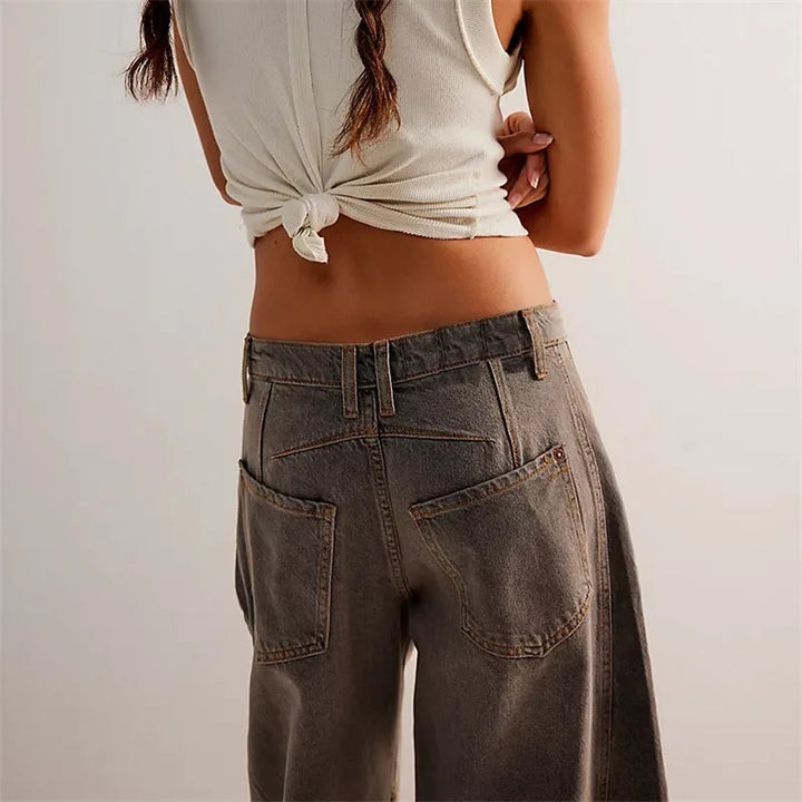 Light blue barrel leg jeans on model, full-length view showing waistband detail