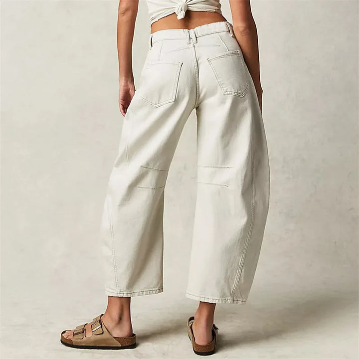 Light blue barrel leg jeans on model, full-length styling view