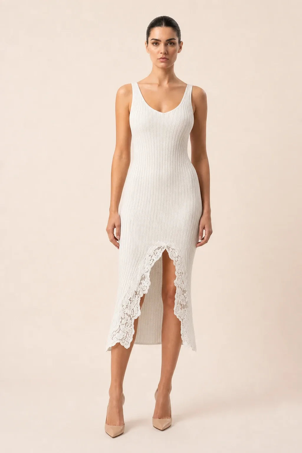White midi dress with lace trim and front slit on model in contrapposto stance