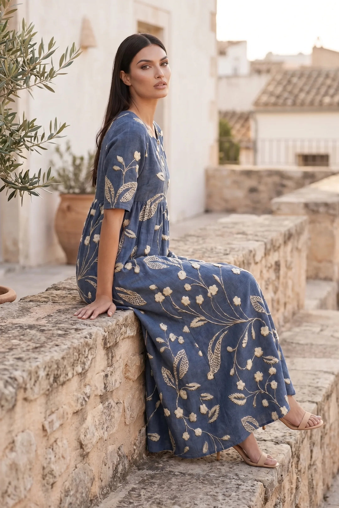 Model wearing navy blue floral midi dress in an outdoor lifestyle setting