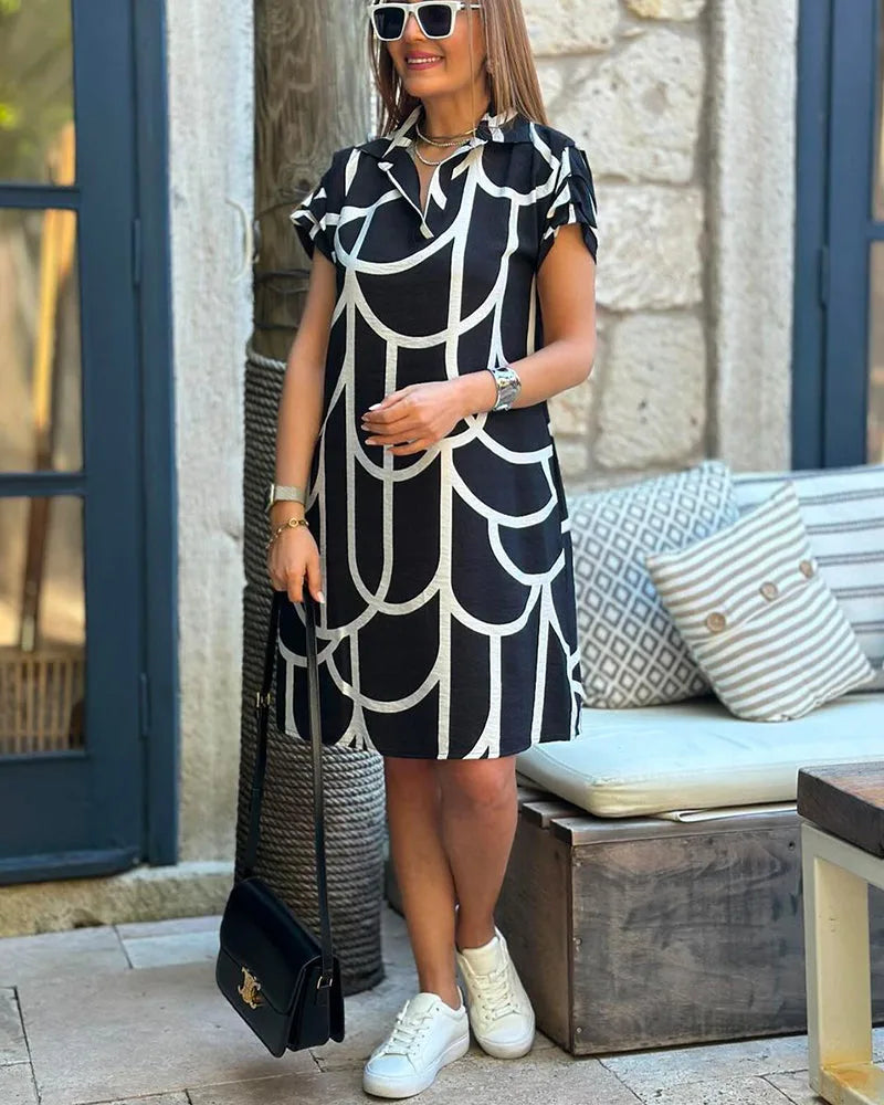 Close-up detail of geometric print pattern on black shift dress