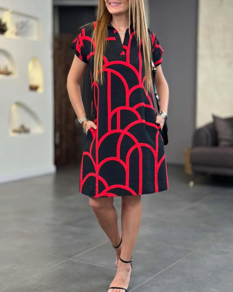 Red geometric print shift dress on model in three-quarter turn