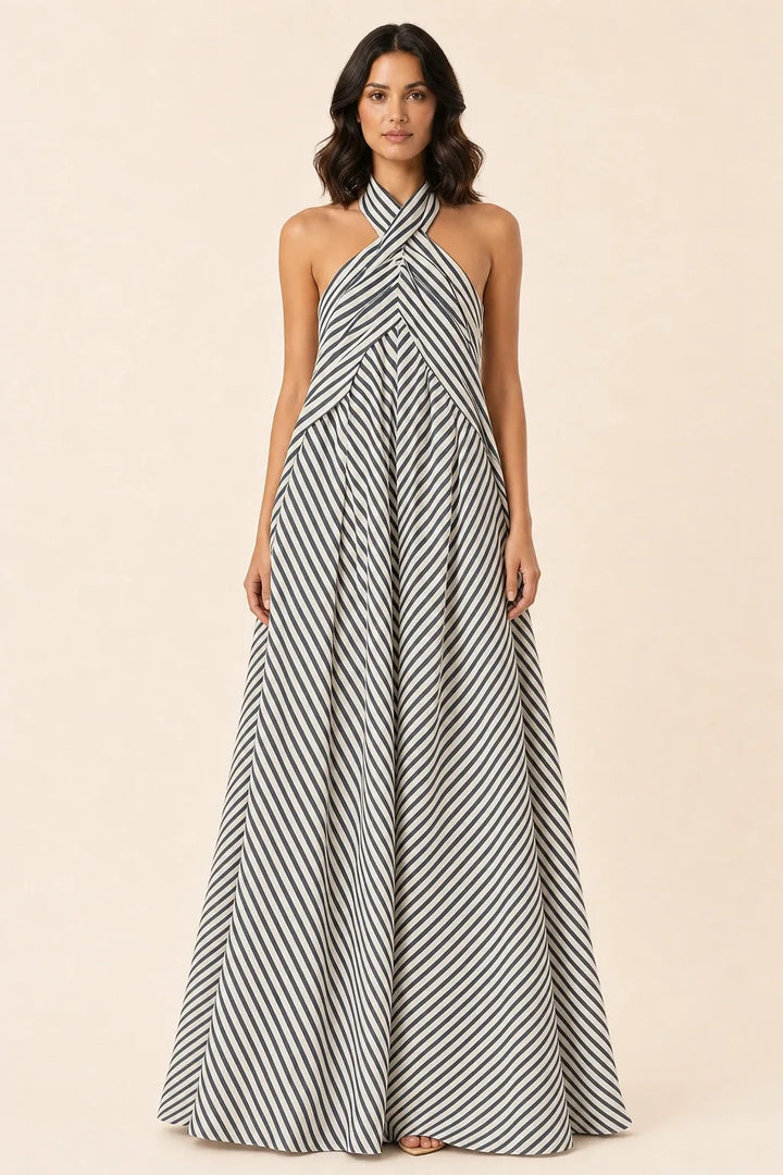 Grey crossover halter maxi dress on model in contrapposto stance
