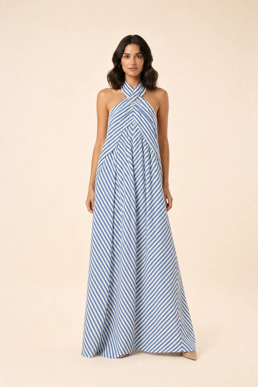 Light blue crossover halter maxi dress on model in contrapposto stance
