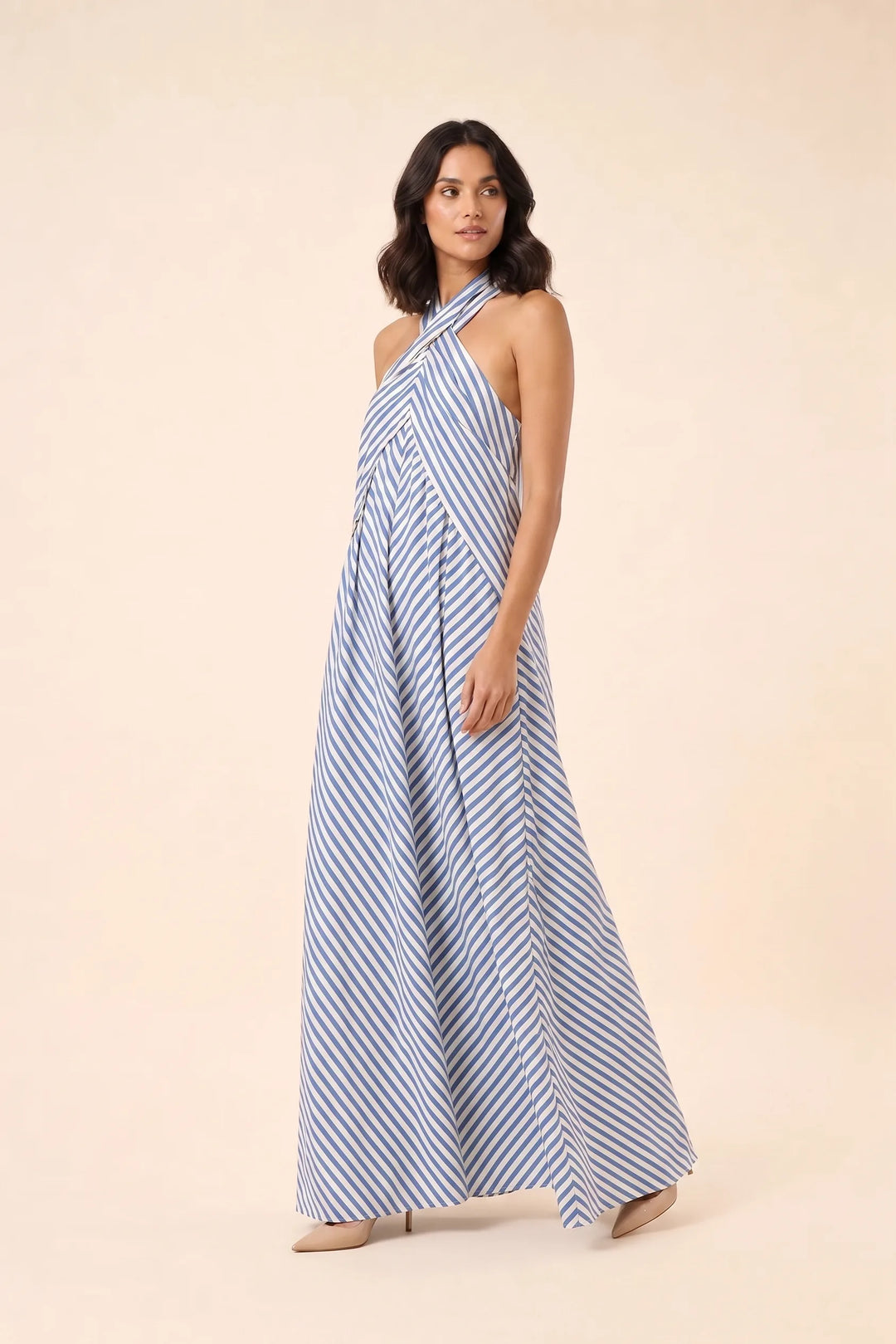 Light blue crossover halter maxi dress on model in three-quarter turn