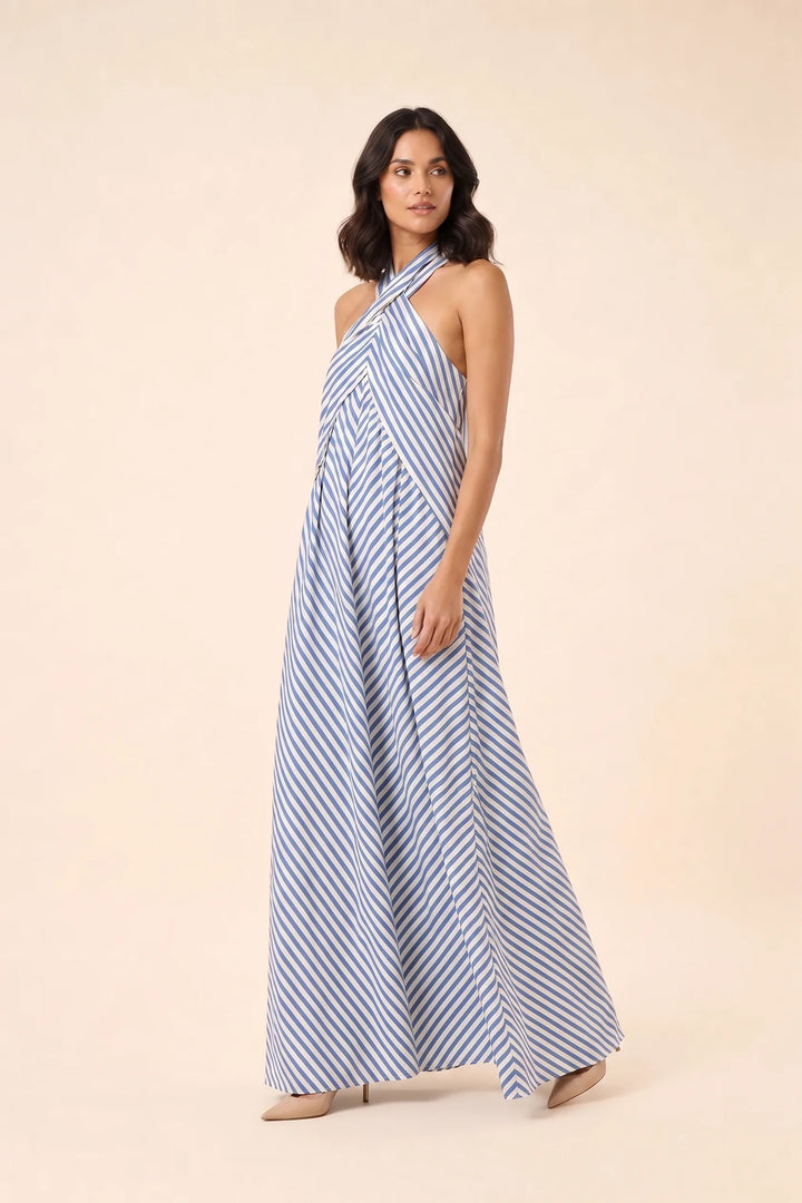 Light blue crossover halter maxi dress on model in three-quarter turn