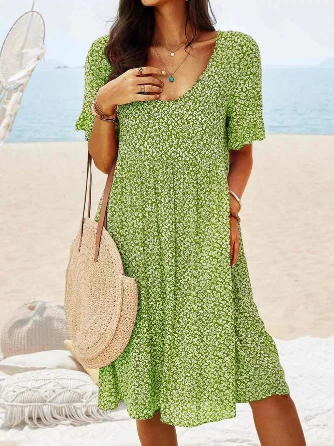 Green floral smock dress, close-up detail of smocking and floral print