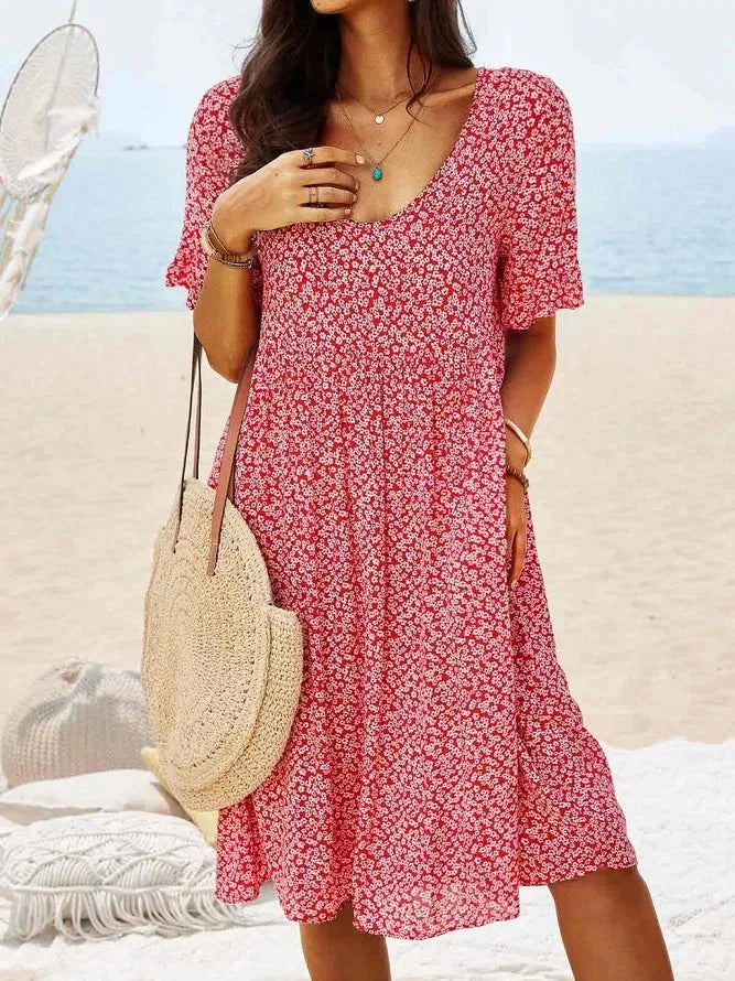 Red floral smock dress, model in three-quarter turn