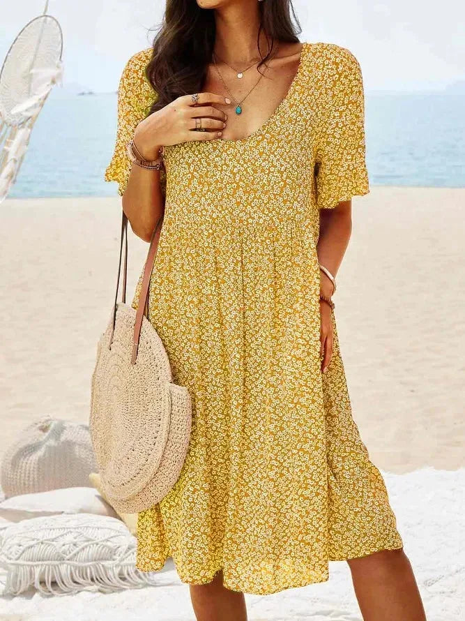 Yellow floral smock dress, model in side profile