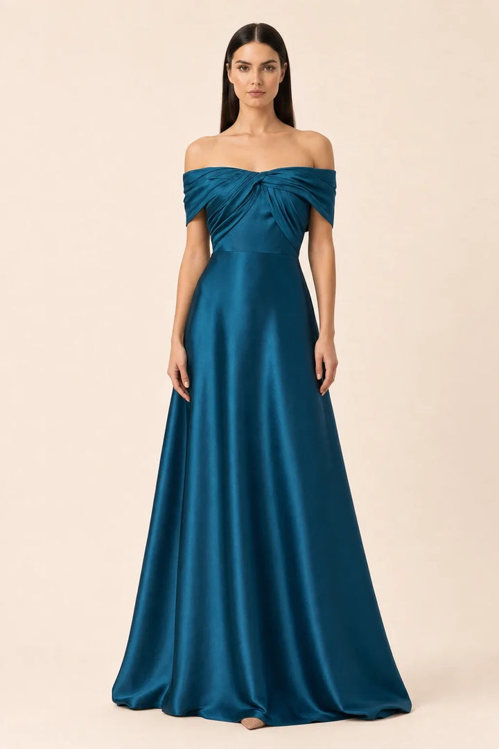 Woman in blue off-shoulder satin gown, weight shifted to one hip in contrapposto stance