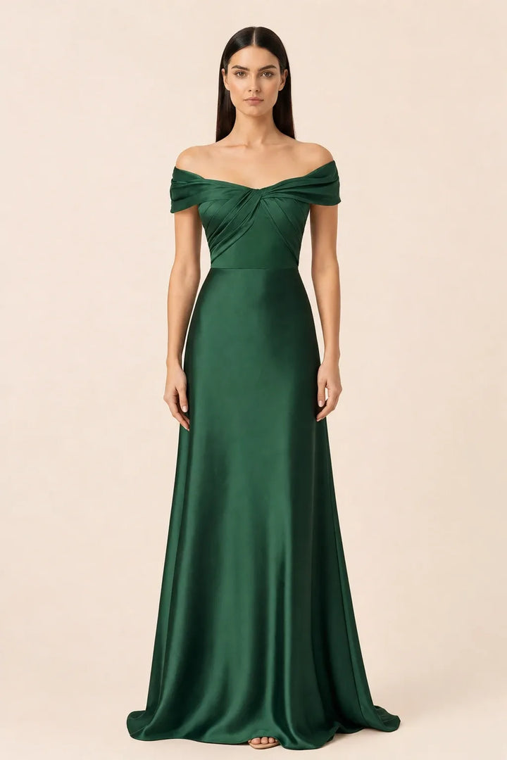 Woman in dark green off-shoulder satin gown, weight shifted to one hip in contrapposto stance