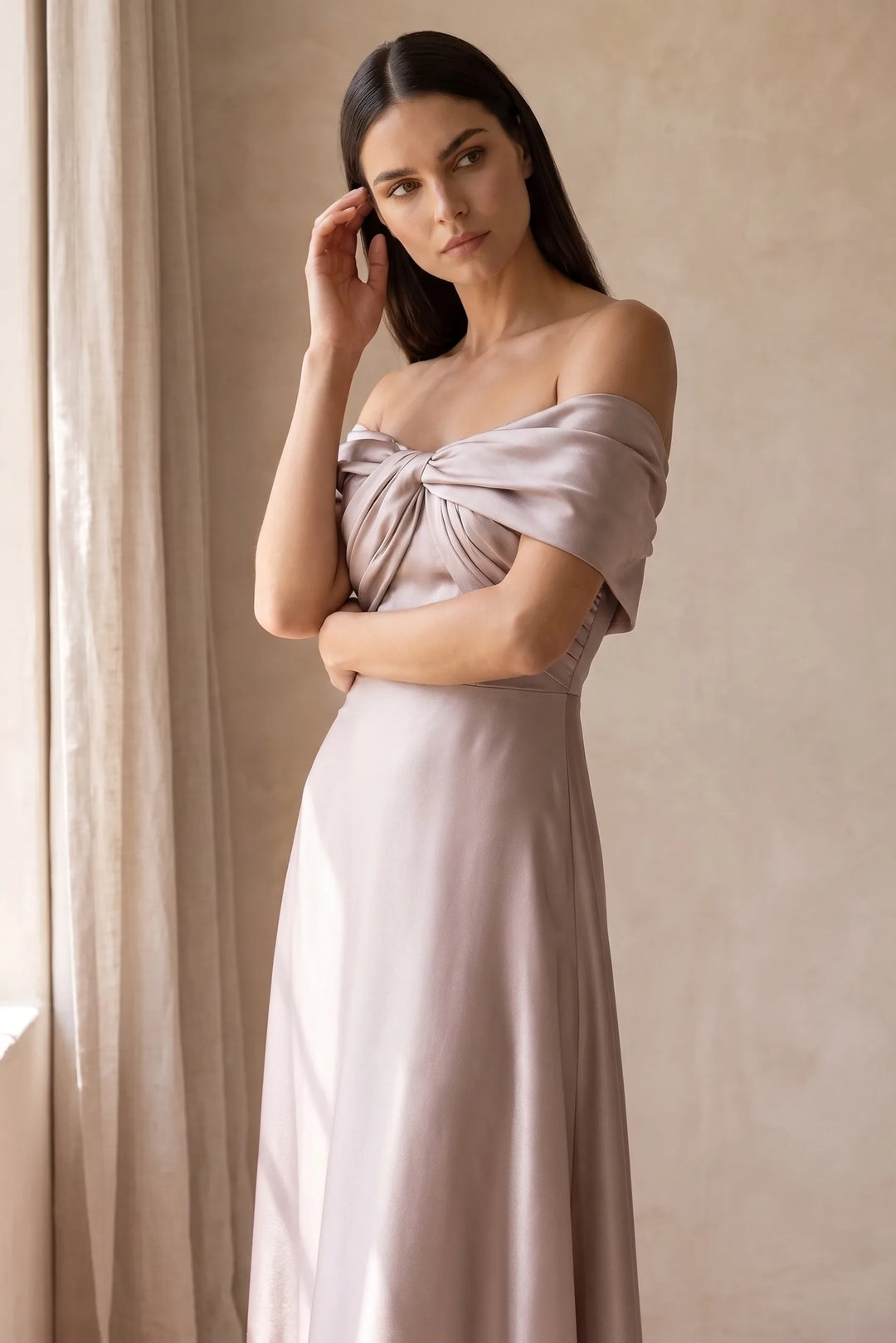 Woman in khaki off-shoulder satin gown in a relaxed lifestyle setting