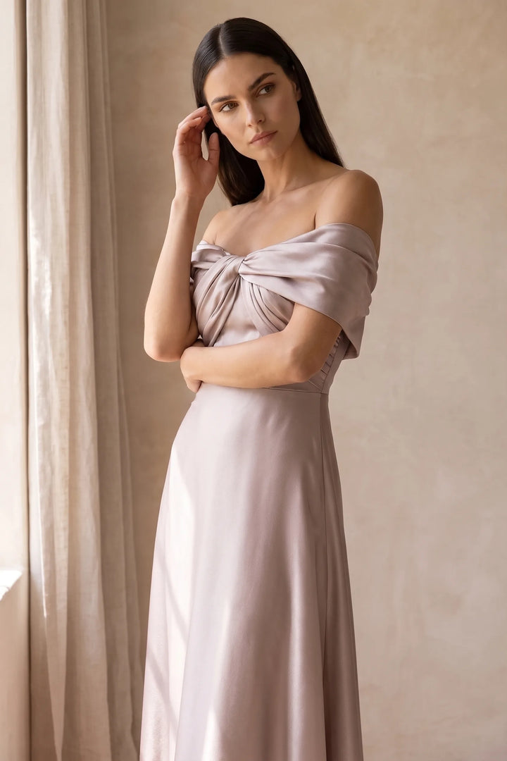 Woman in khaki off-shoulder satin gown in a relaxed lifestyle setting
