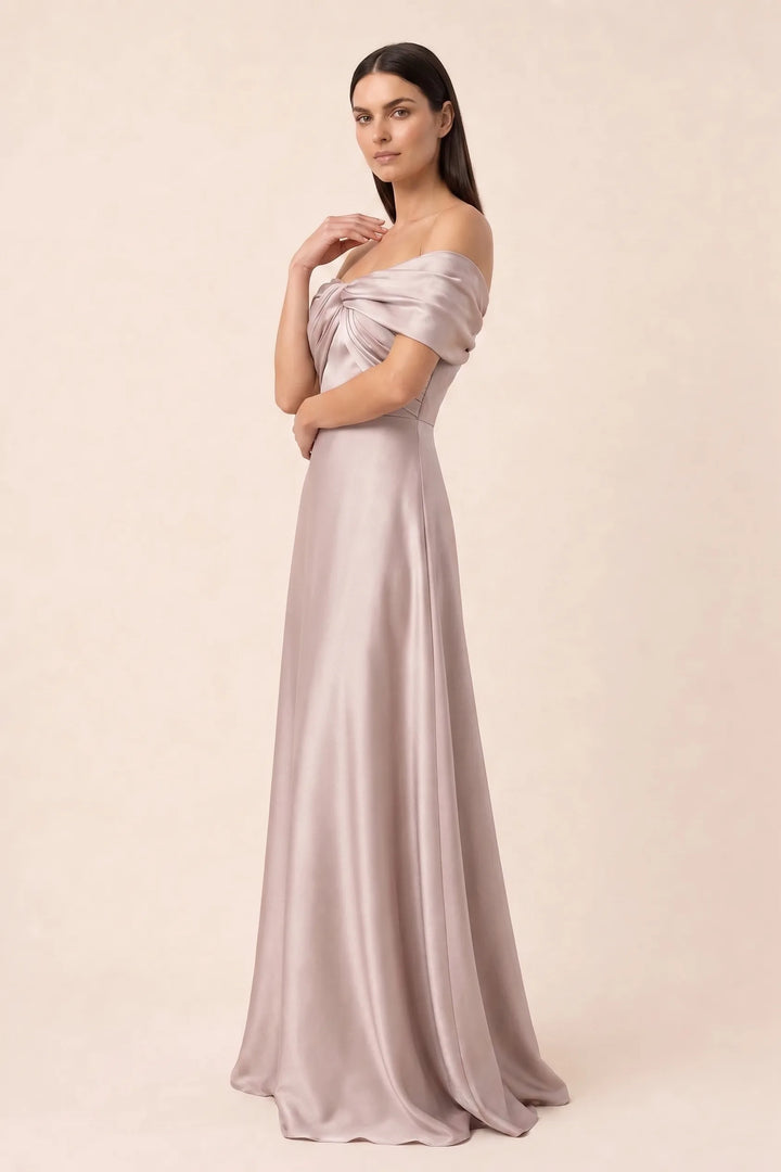 Woman in khaki off-shoulder satin gown, shown from a three-quarter angle
