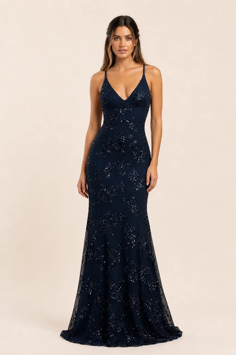 Dark blue sequin lace-up gown on model in contrapposto stance