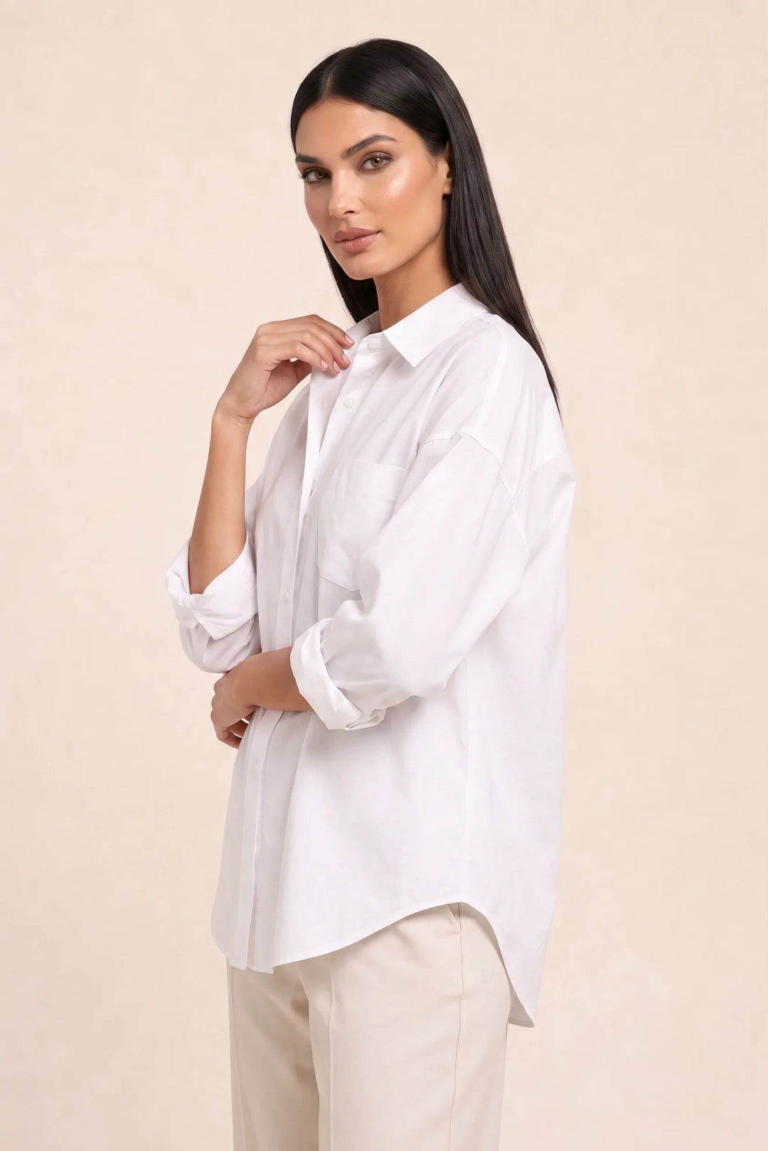 White oversized button-down shirt on model in three-quarter turn