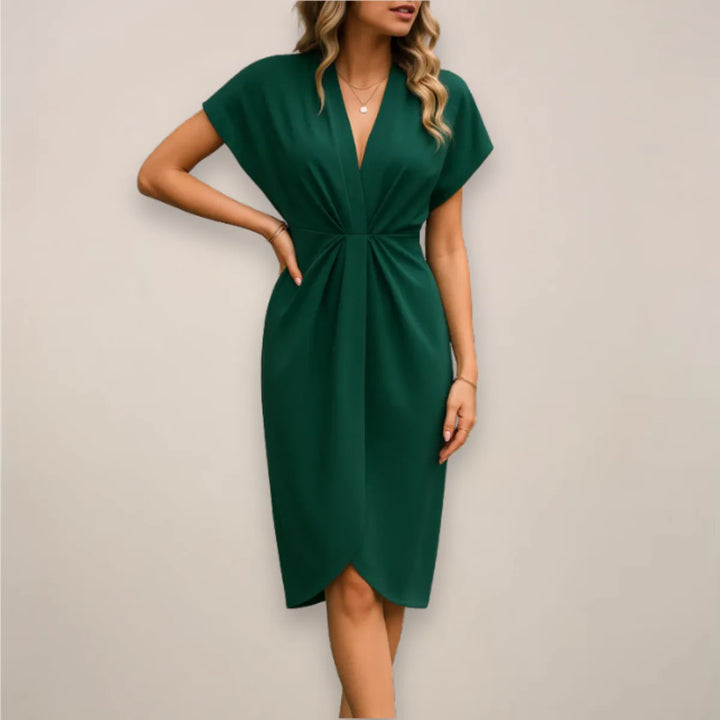 Close-up detail of dark green twist front midi dress neckline