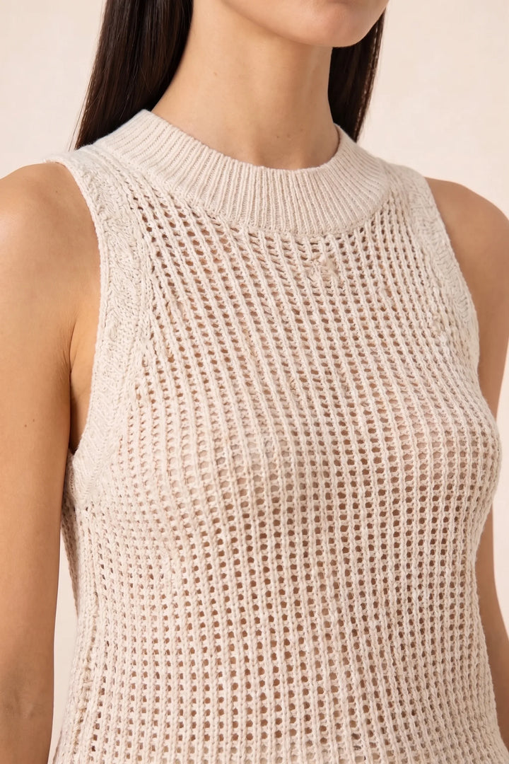 Close-up detail of apricot open knit tank top fabric and texture