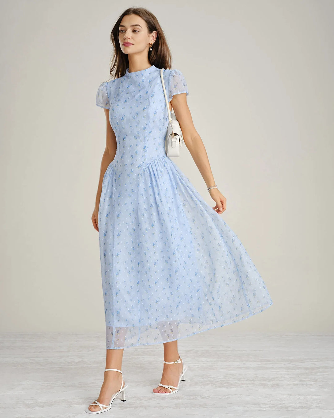 Close-up detail of blue chiffon drop waist midi dress fabric and silhouette