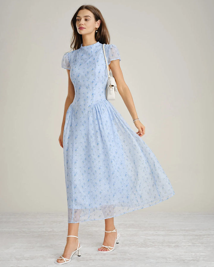 Close-up detail of blue chiffon drop waist midi dress fabric and silhouette