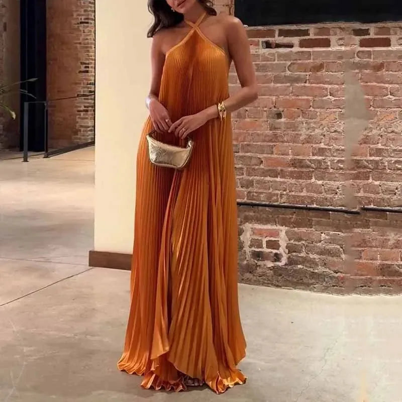 Orange pleated halter maxi dress on model facing forward, full-length view
