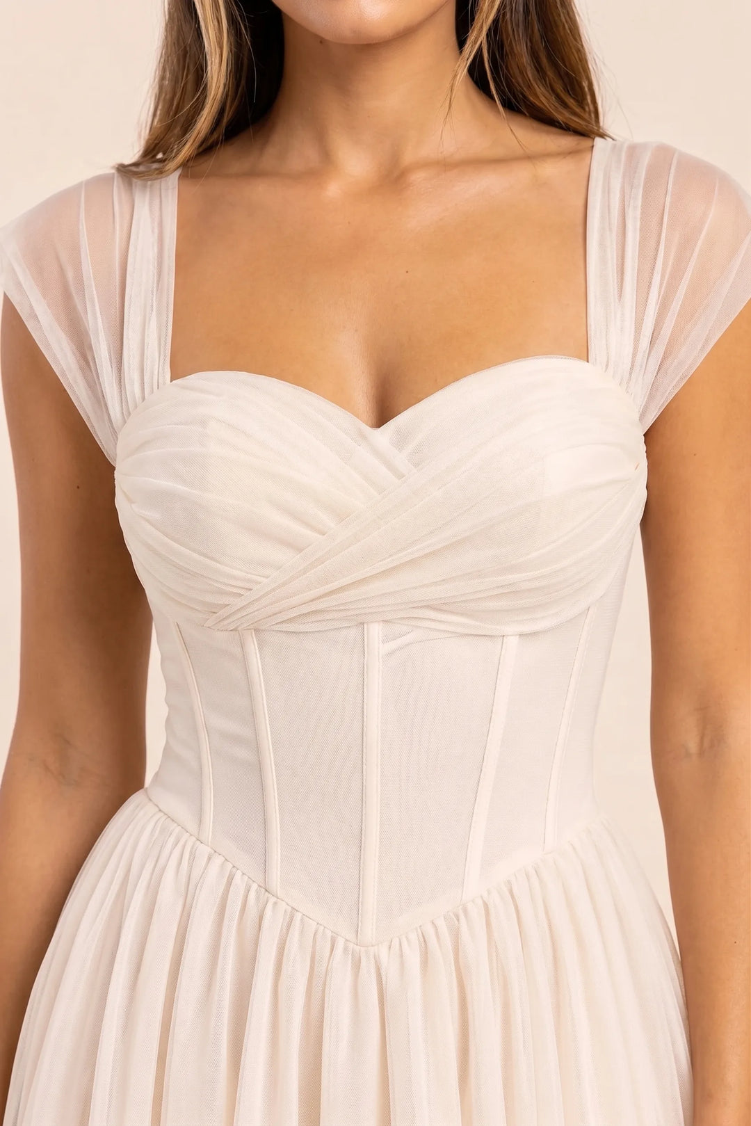 Close-up detail of apricot corset tulle midi dress boning and fabric