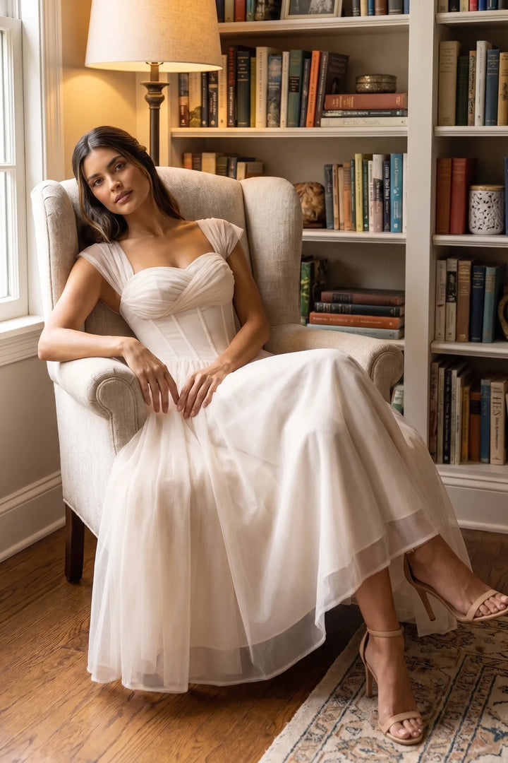 Model wearing apricot corset tulle midi dress in outdoor lifestyle setting