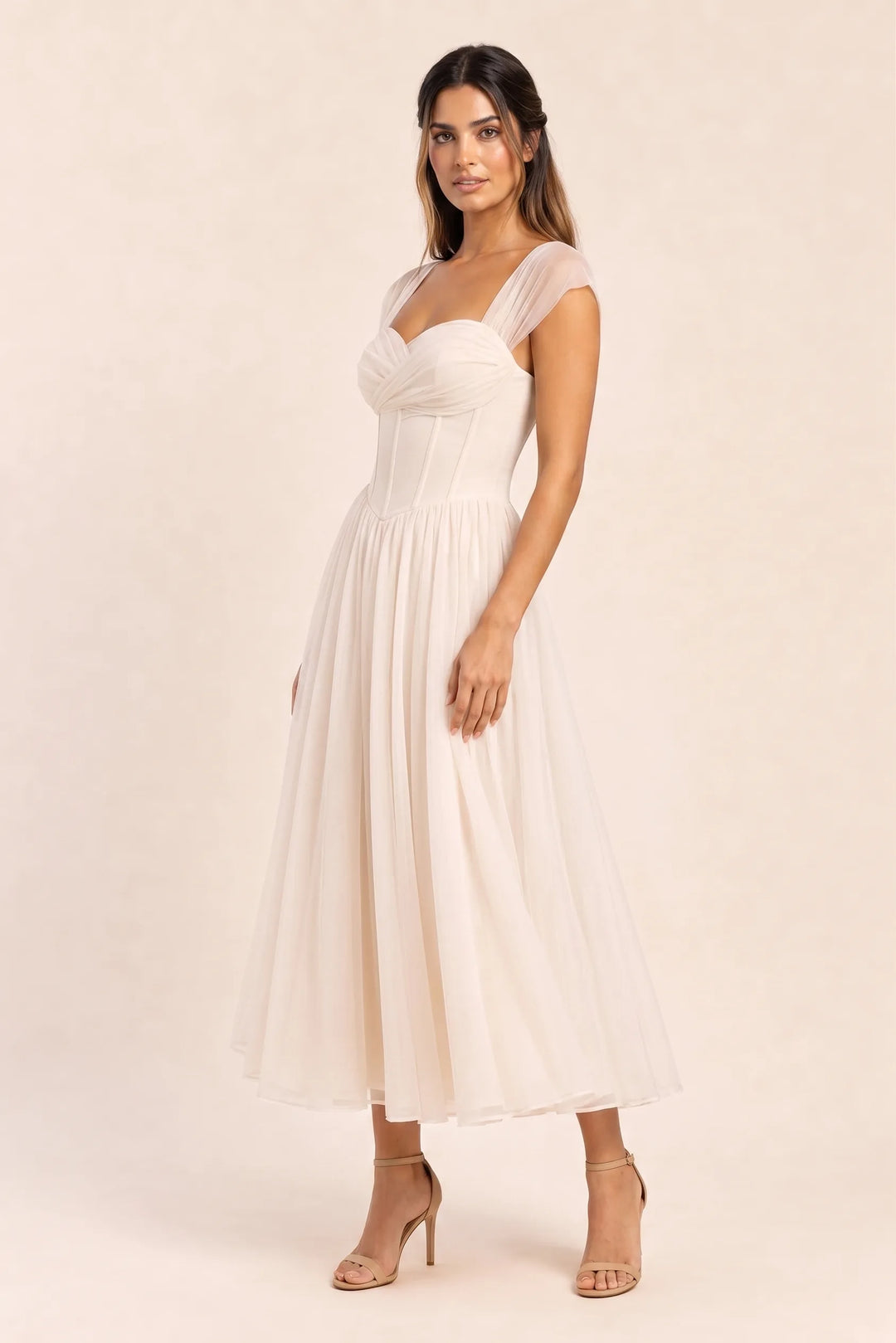 Apricot corset tulle midi dress on model in three-quarter turn