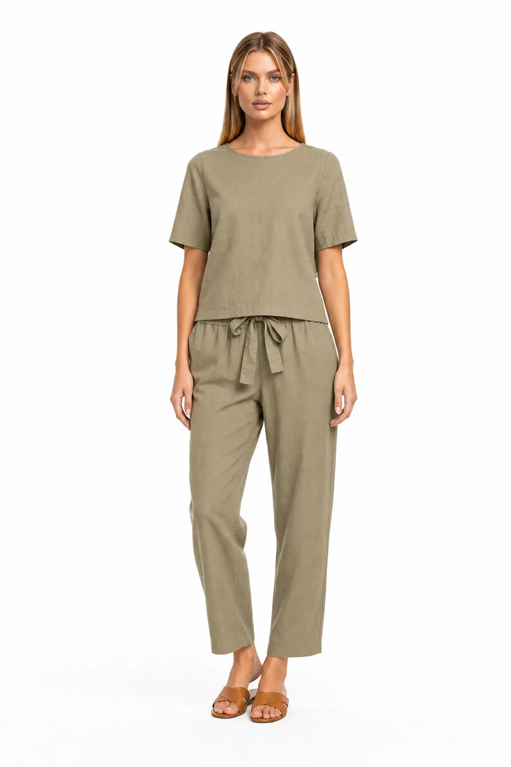 Khaki linen crop top on model in relaxed contrapposto stance