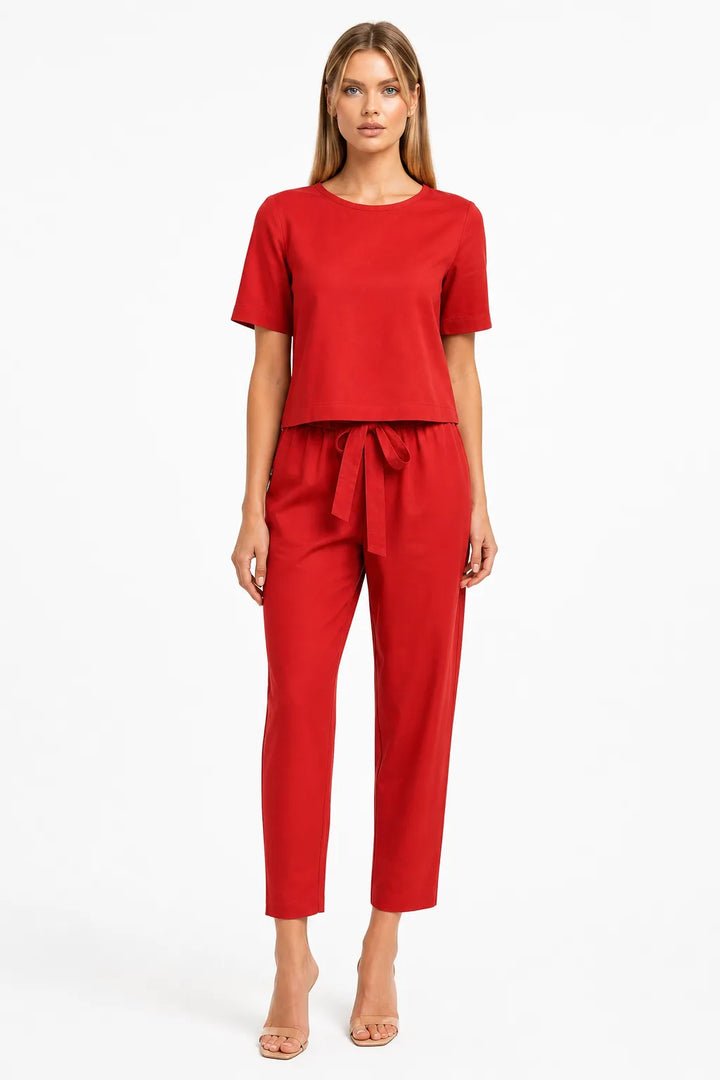 Red linen crop top on model in relaxed contrapposto stance