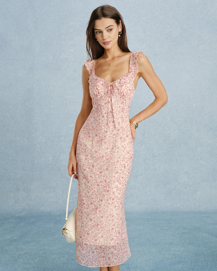 Model facing forward in a pink ruffle-strap midi dress with tiered skirt