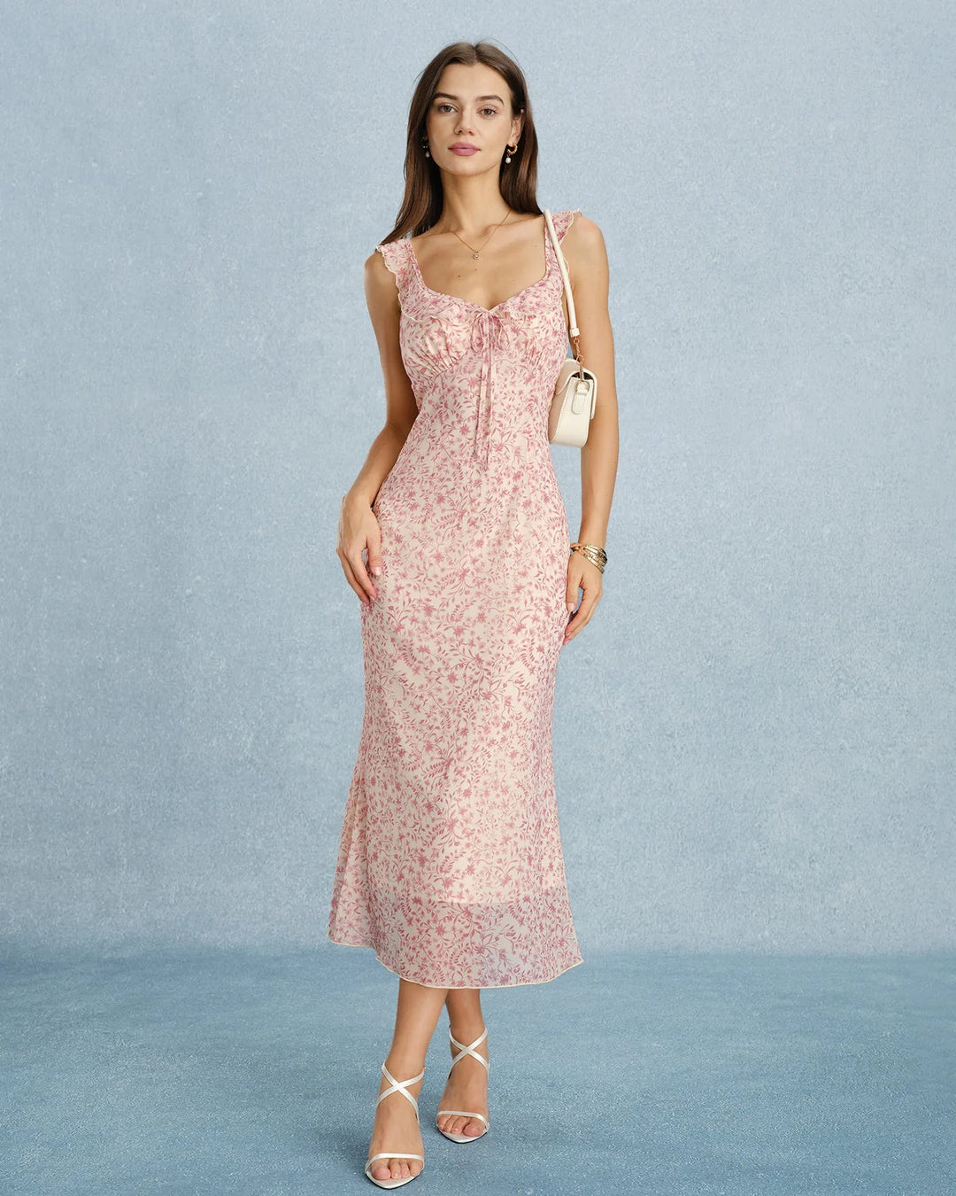 Full-length view of model in a pink ruffle-strap midi dress