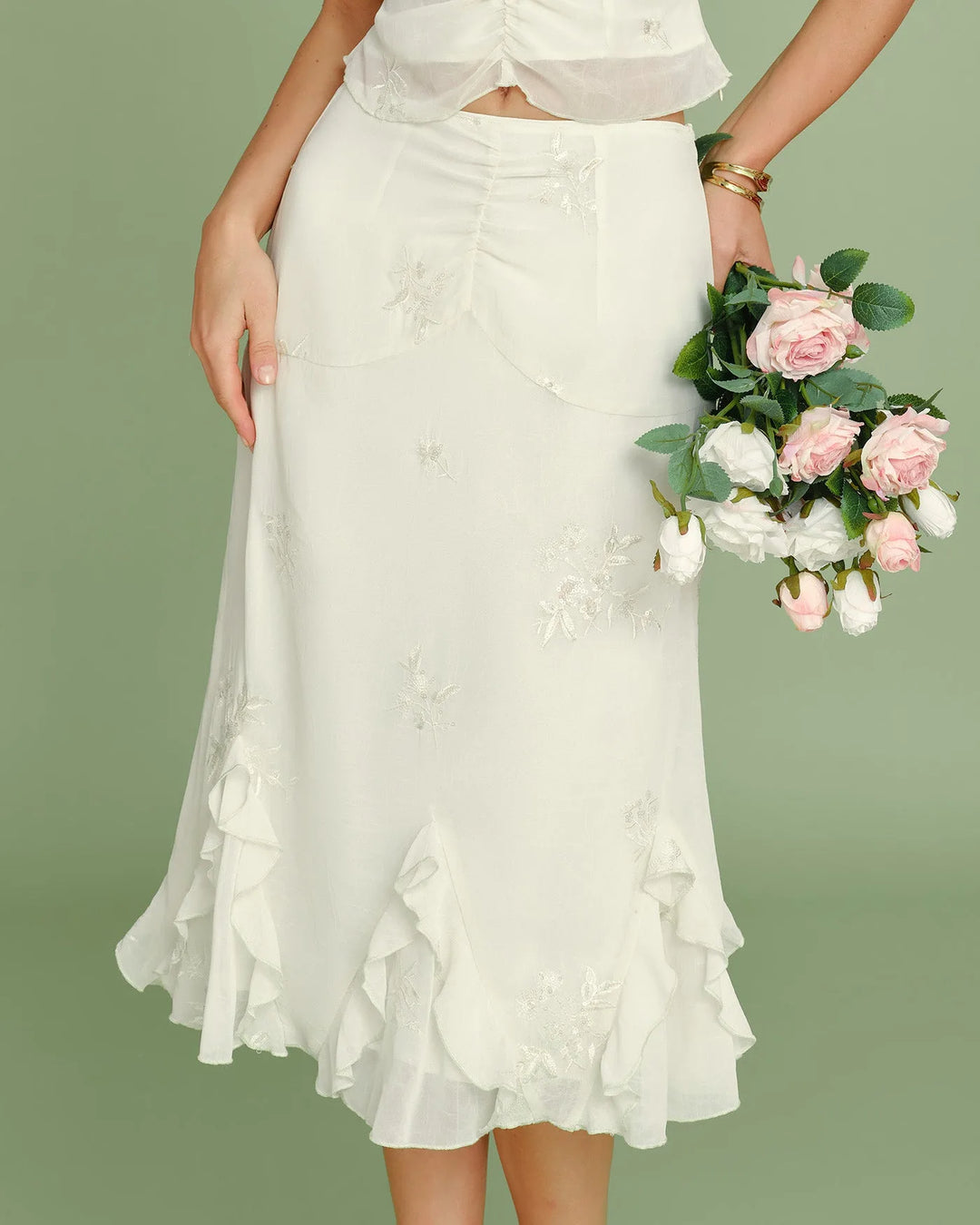Apricot ruched embroidered midi skirt on model facing forward