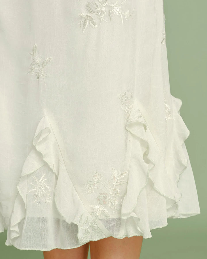 Apricot ruched embroidered midi skirt on model from the side