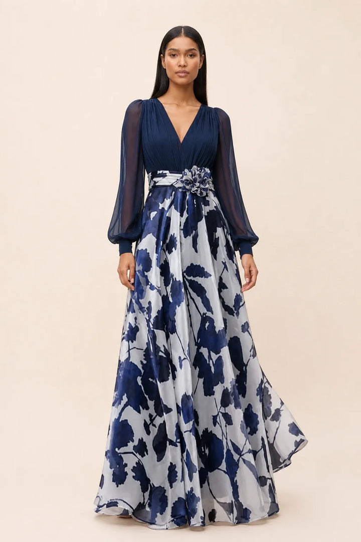Navy blue floral maxi dress with balloon sleeves on a model in a contrapposto stance