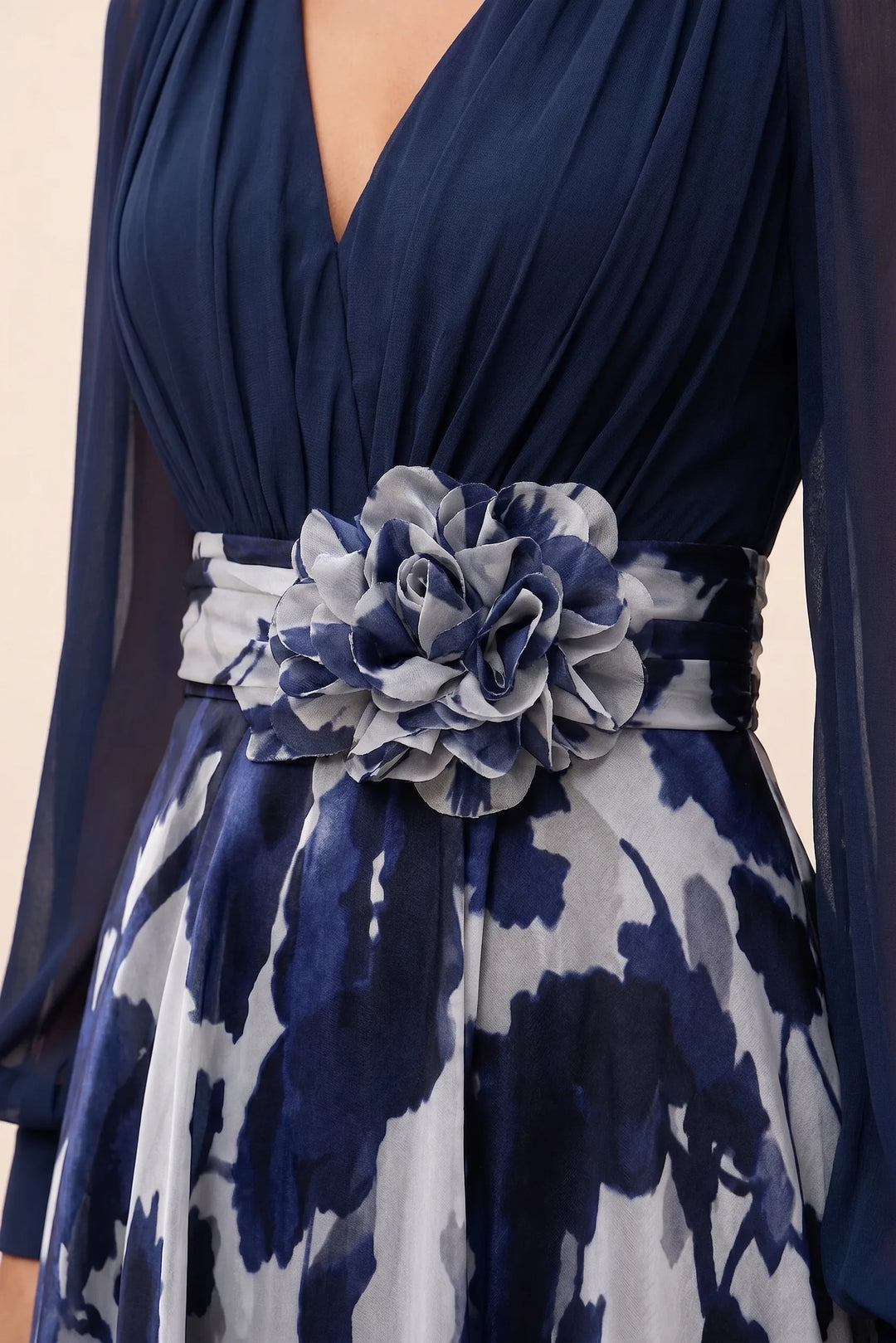 Close-up detail of a navy blue floral maxi dress with balloon sleeves