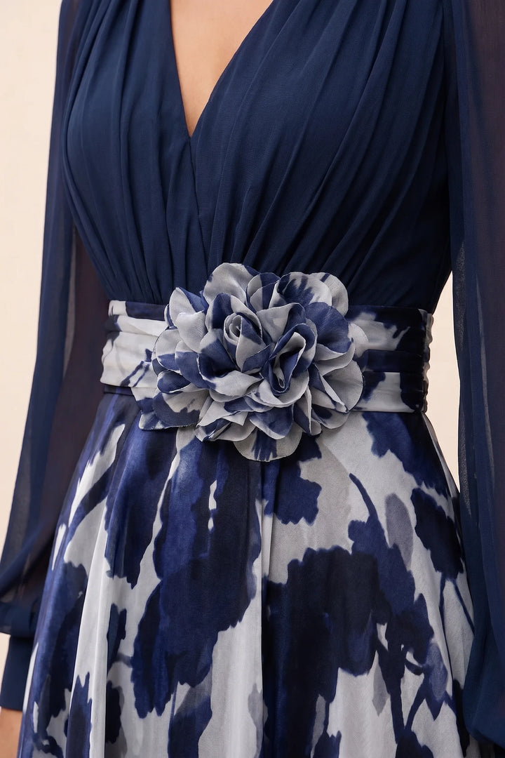 Close-up detail of a navy blue floral maxi dress with balloon sleeves