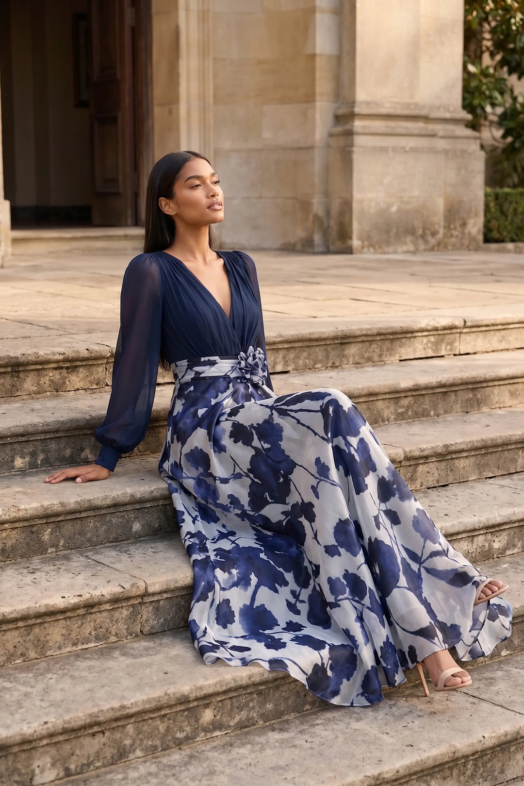 Model wearing a navy blue floral balloon sleeve maxi dress in an outdoor lifestyle setting