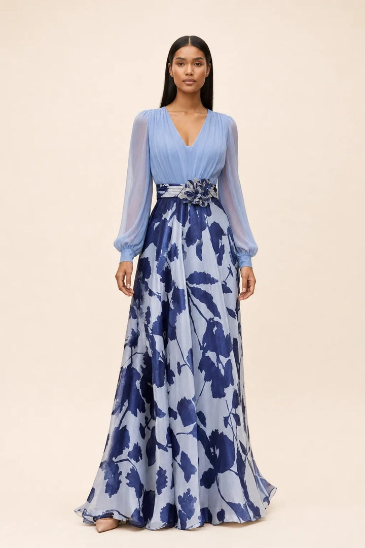 Pale blue floral maxi dress with balloon sleeves on a model in a contrapposto stance