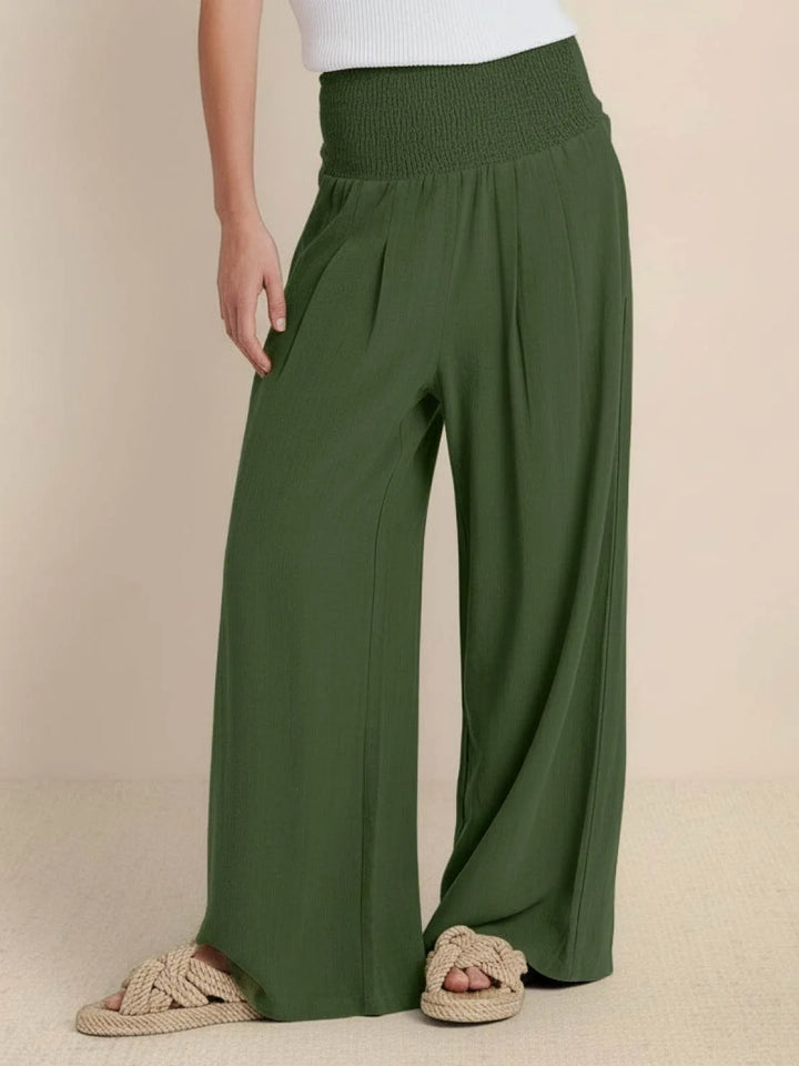 Army green smocked wide leg pants on model, full-length view