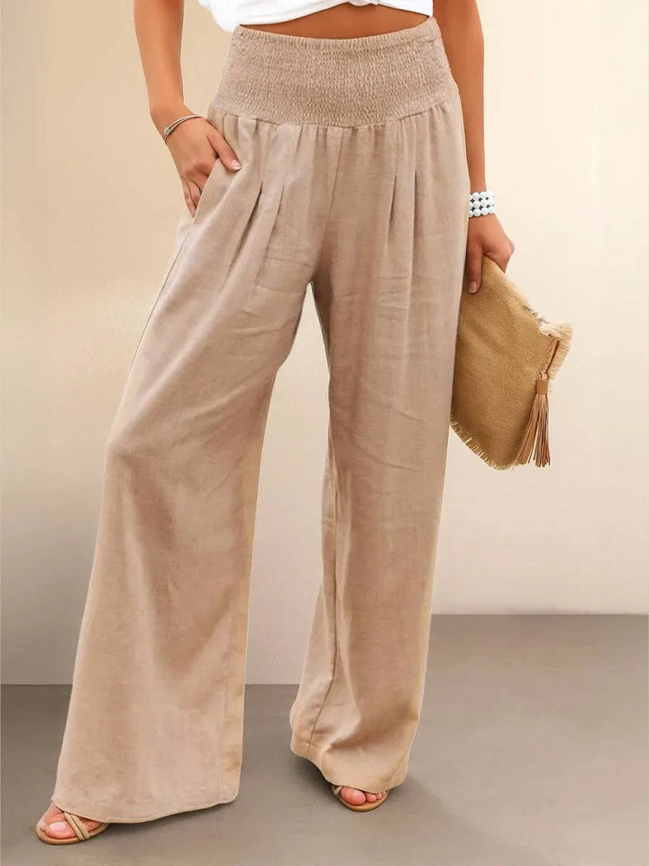 Khaki smocked wide leg pants on model, front view