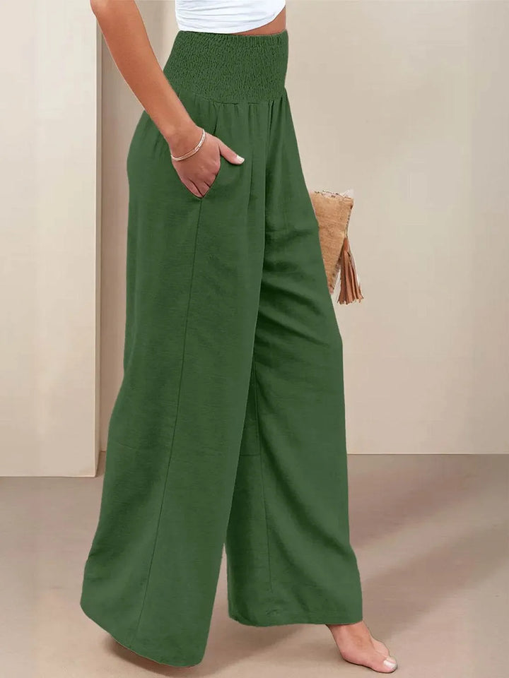 Khaki smocked wide leg pants on model, standing styled view