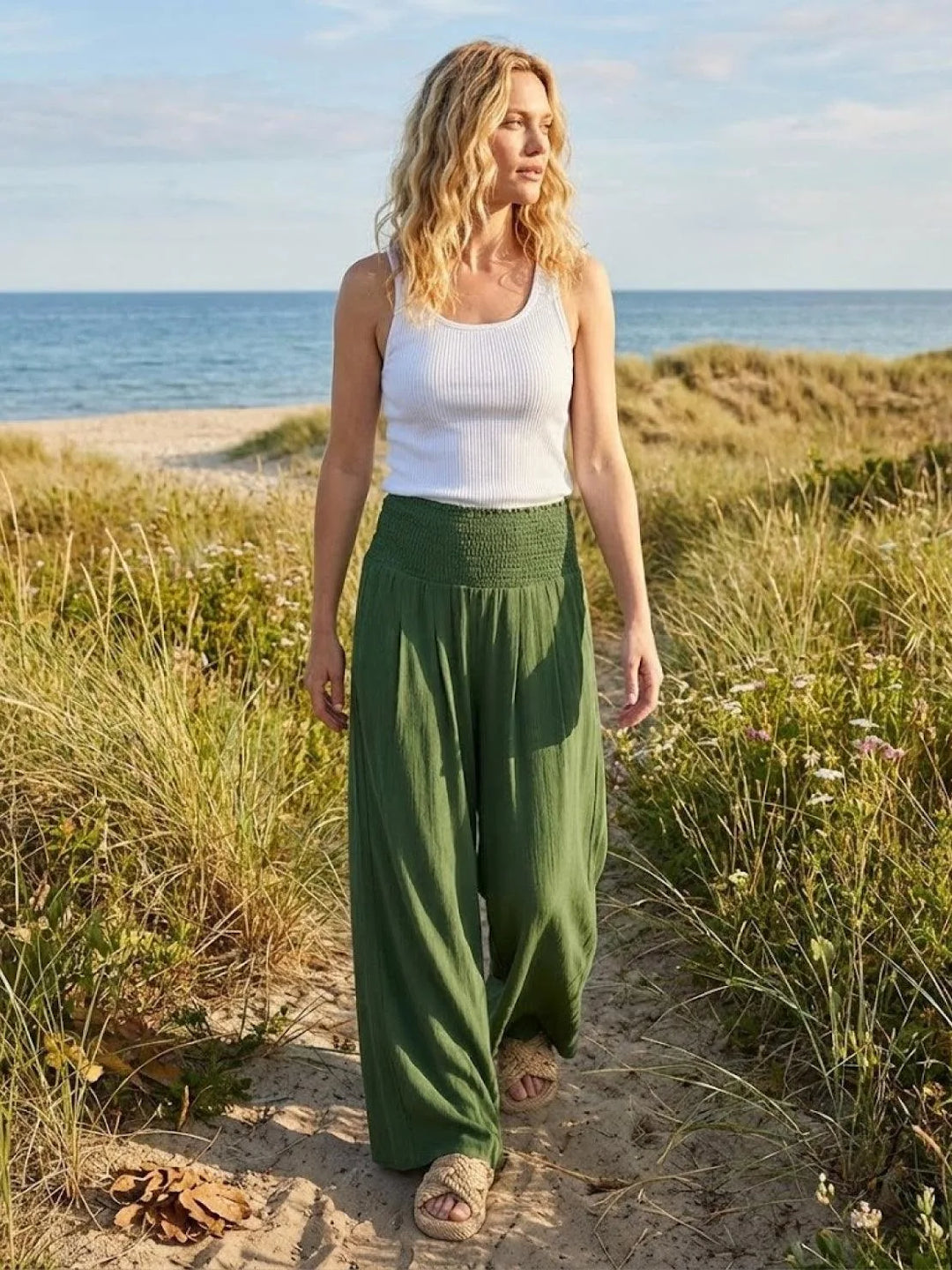 Khaki smocked wide leg pants on model, cropped lower-body view