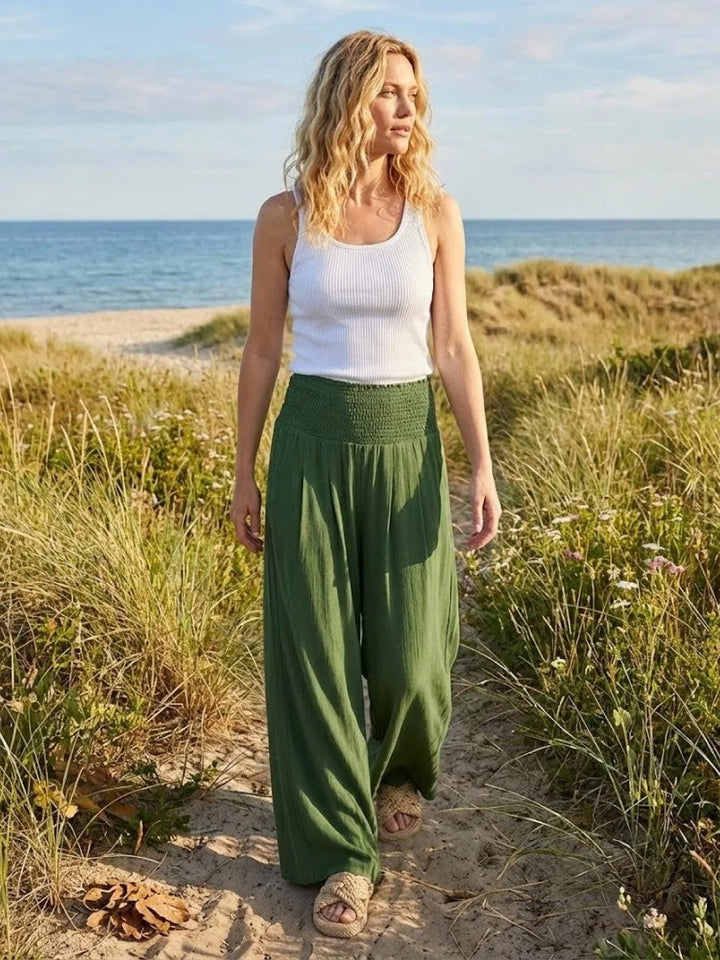 Khaki smocked wide leg pants on model, cropped lower-body view