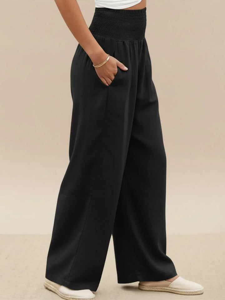 Khaki smocked wide leg pants on model, styled standing view