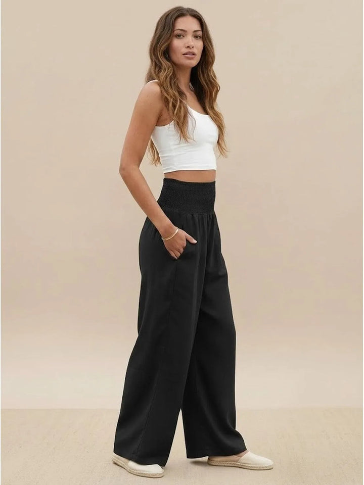 Khaki smocked wide leg pants on model, front standing pose
