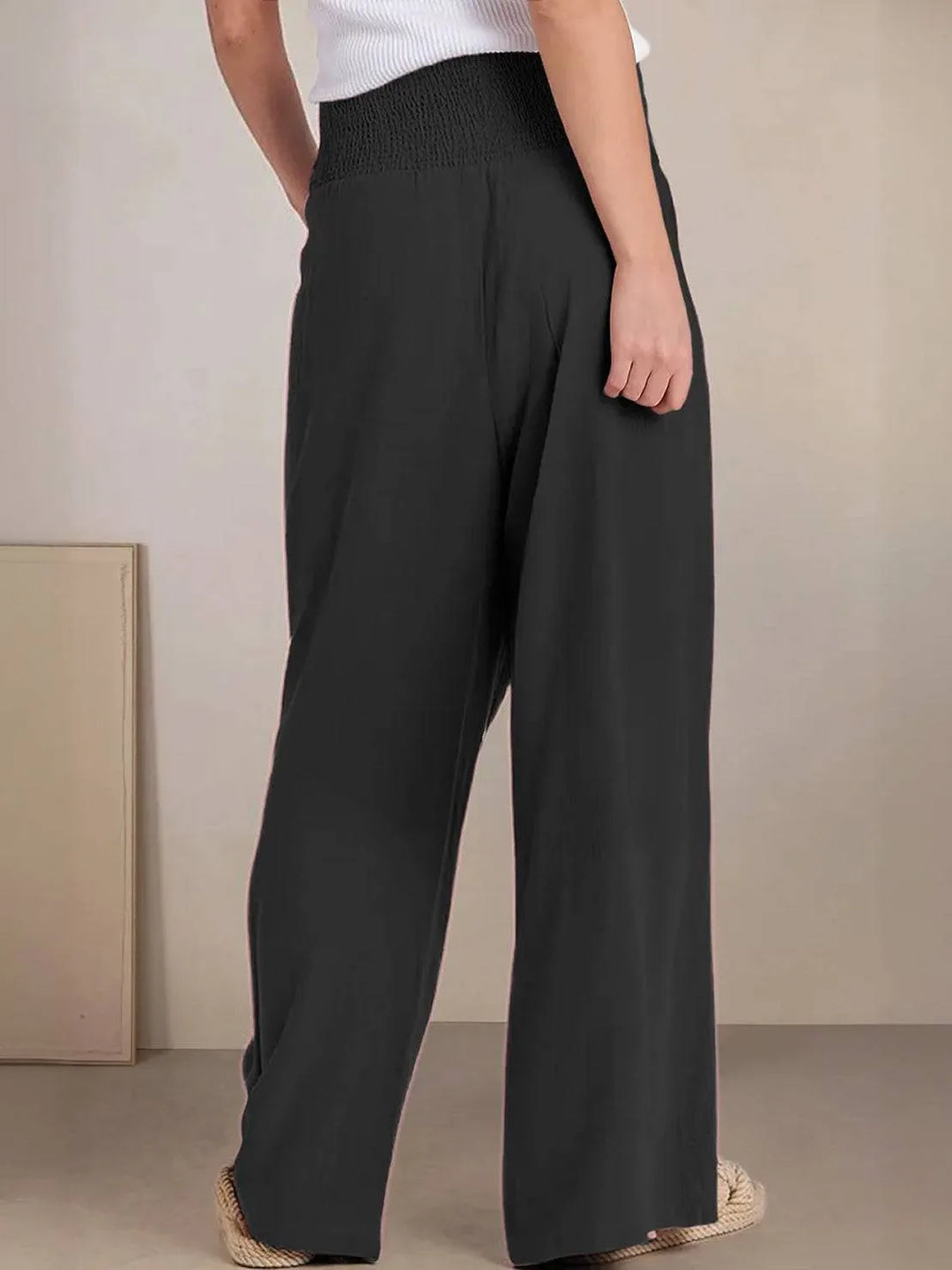 Khaki smocked wide leg pants on model, angled standing view