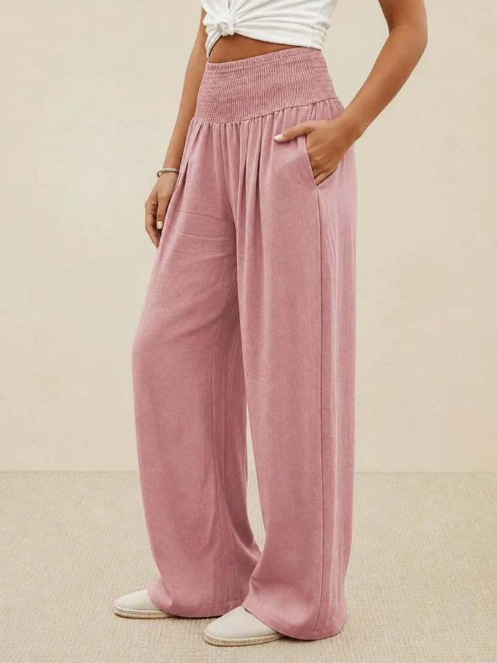 Khaki smocked wide leg pants on model, close full-length view