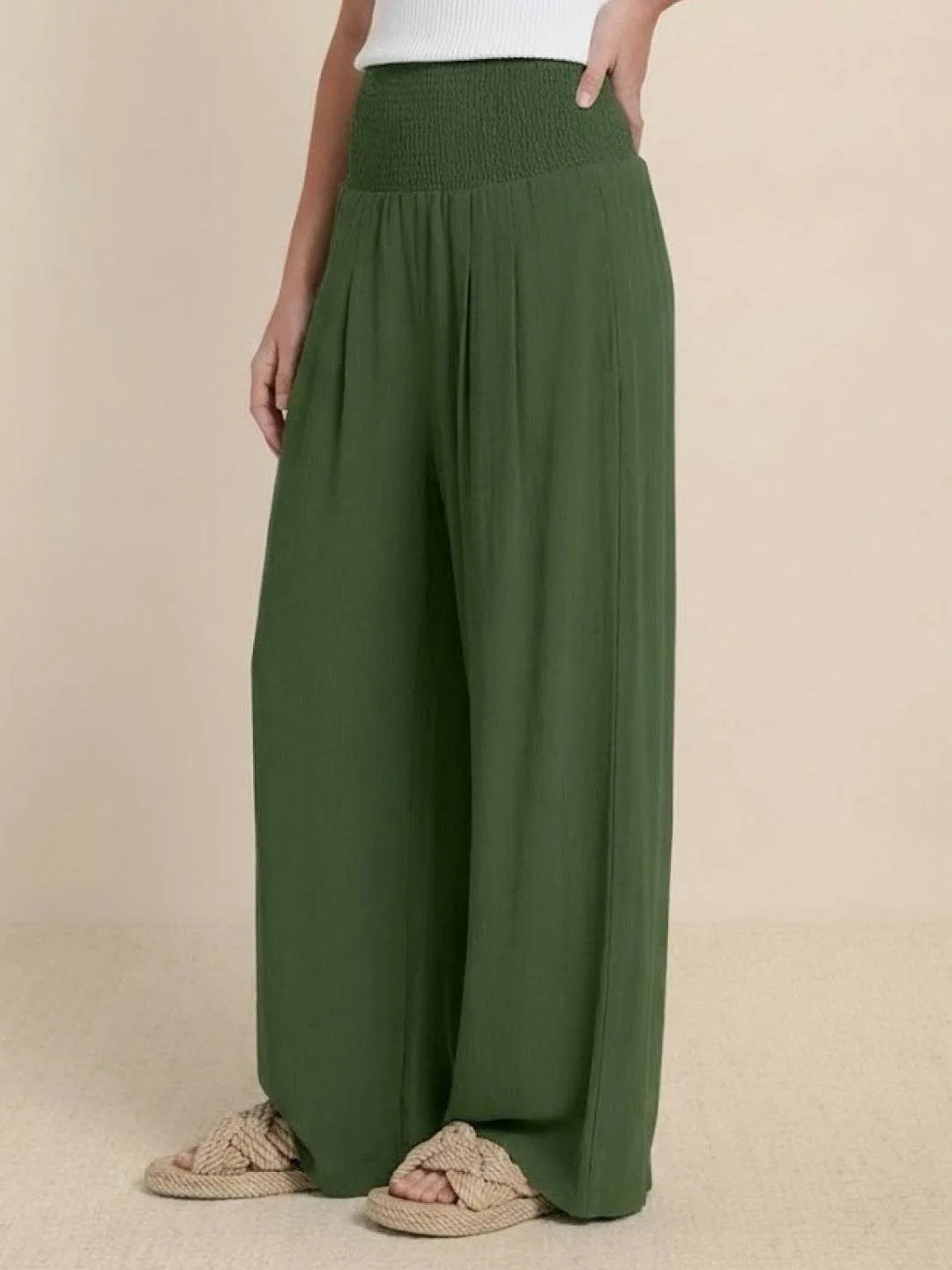 Khaki smocked wide leg pants on model, relaxed standing pose