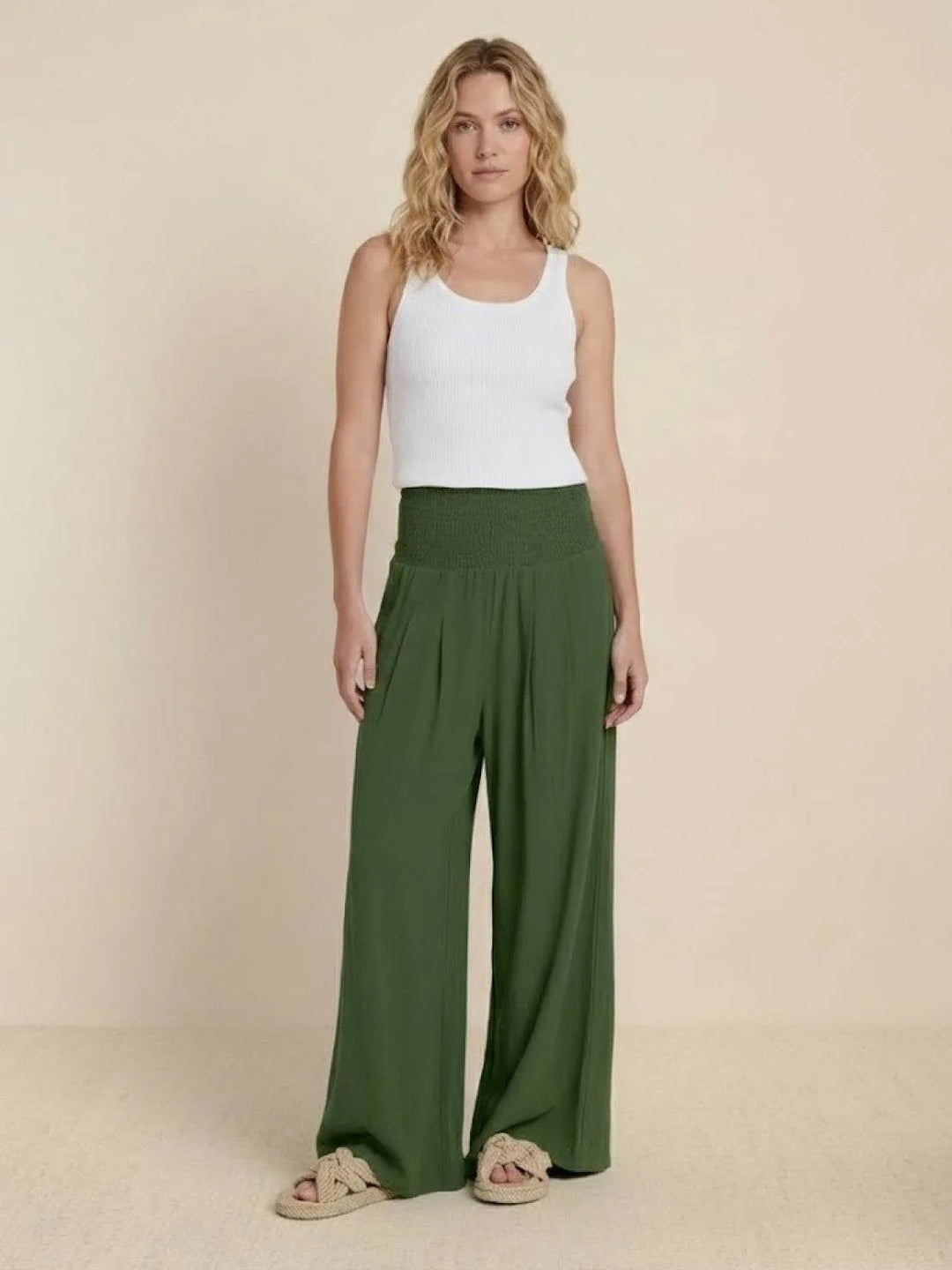 Khaki smocked wide leg pants on model, angled full-length view